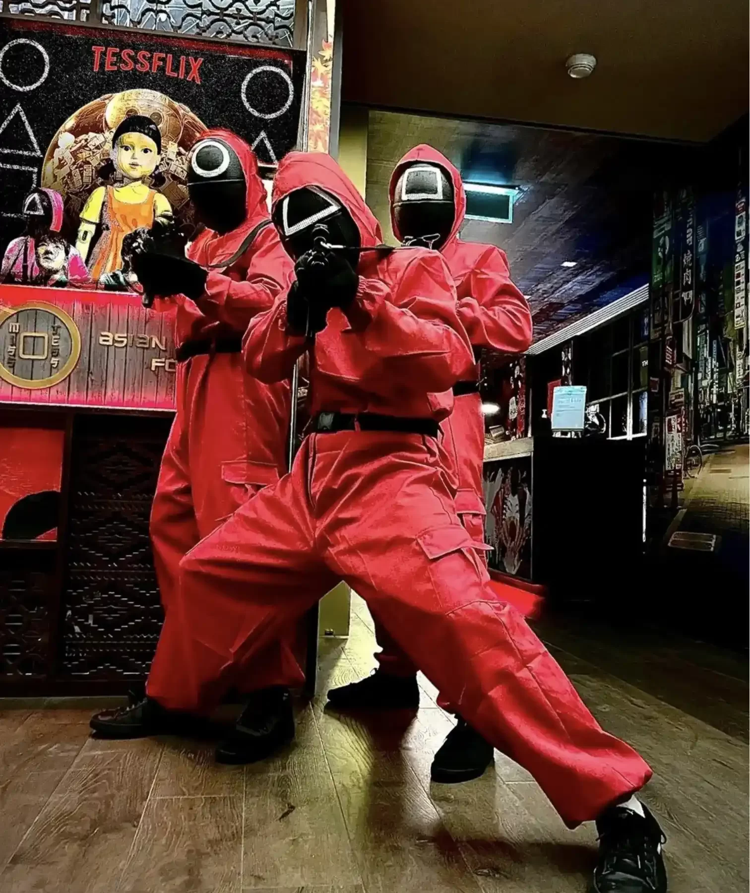 three people dressed as a squid game